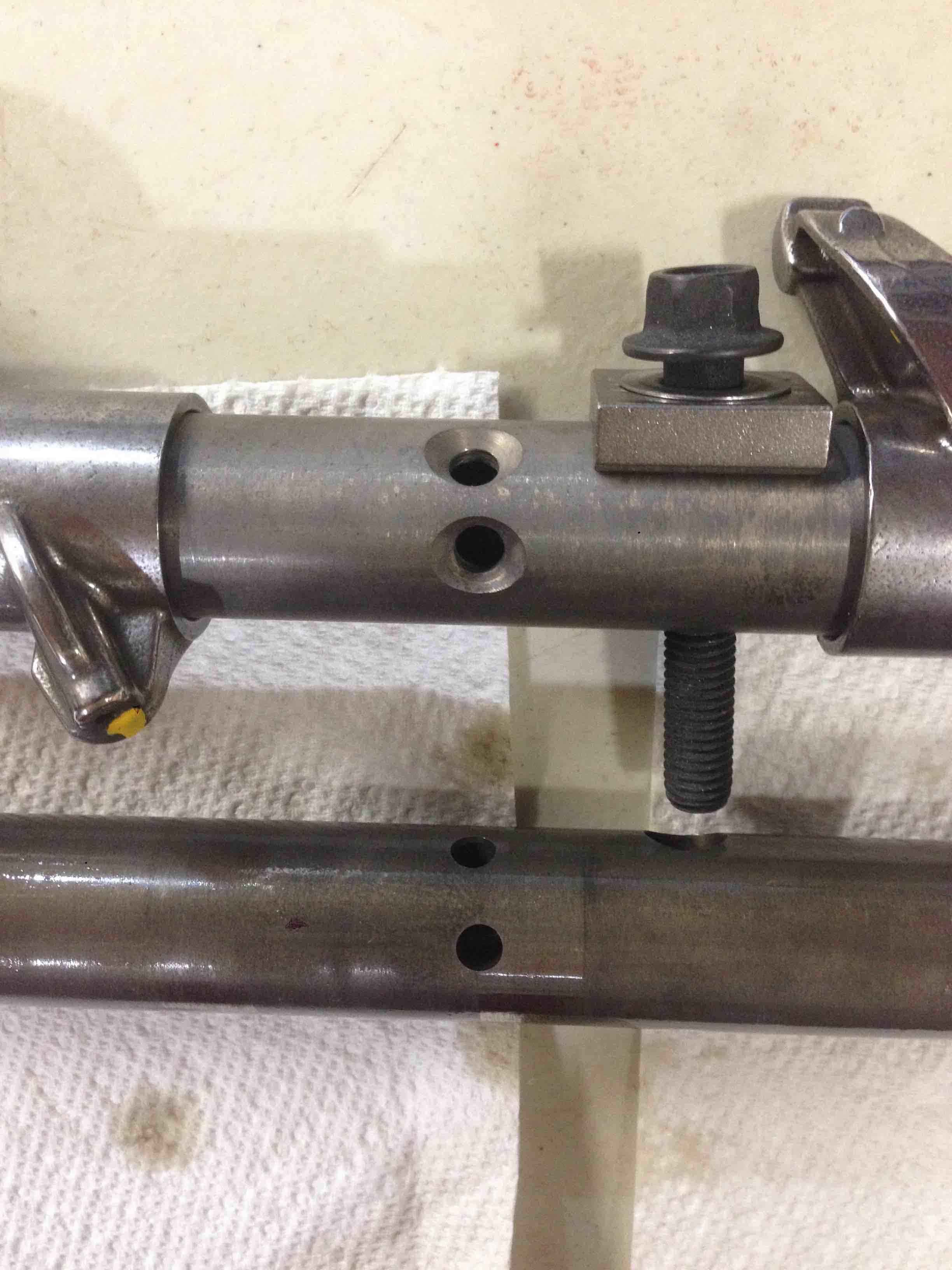 Attached picture New vs Old Rocker Shafts - Chamfered oil holes.jpg